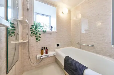 a bathroom with a tub and a glass shower at Fuufu House Tokyo Yotsuya - No Elevator 3F WalkUp in Tokyo