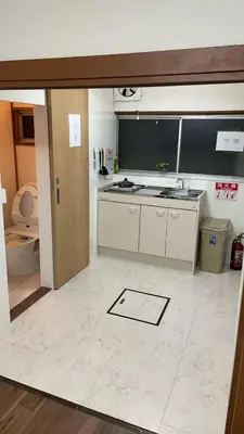 a kitchen with a sink and a counter at \u53cc\u9b5a\u306e\u5bbf\u6c60\u888b in Tokyo