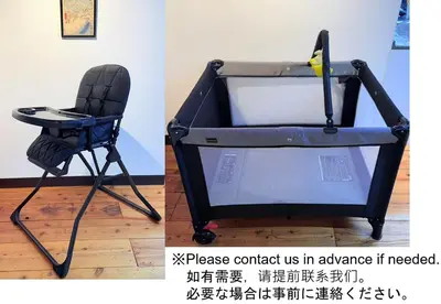 a black folding chair sitting next to a wall at GARDEN HOUSE Tameike-Sanno in Tokyo