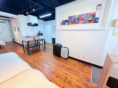 a room with a living room with a table and chairs at GARDEN HOUSE Tameike-Sanno in Tokyo