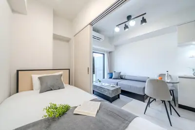 a bedroom with a bed and a couch at Daffitto\u62bc\u4e0aII in Tokyo