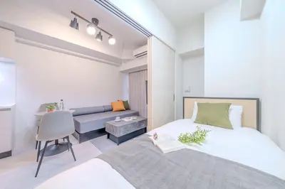 a small bedroom with a bed and a desk at Daffitto\u62bc\u4e0aII in Tokyo