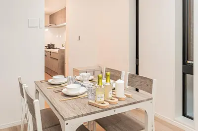 a dining room table with plates and glasses on it at \u685c\u306e\u5ddd70-41 \u7a32\u8377\u753a\u99c5 \u8fd1\u4e0a\u91ce-\u6d45\u8349 2-8\u4eba\u4e28 Inaricho Station, Near Ueno, Asakusa 2-8 people in Tokyo