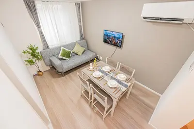 a small living room with a table and a couch at \u685c\u306e\u5ddd70-41 \u7a32\u8377\u753a\u99c5 \u8fd1\u4e0a\u91ce-\u6d45\u8349 2-8\u4eba\u4e28 Inaricho Station, Near Ueno, Asakusa 2-8 people in Tokyo