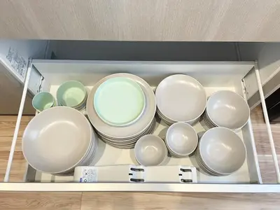 a bunch of plates and bowls in a drawer at A home that captures the colors and spirit of Japan in Tokyo