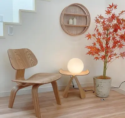 a wooden chair and a table and a plant at A home that captures the colors and spirit of Japan in Tokyo