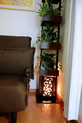 a living room with a chair and some plants at Ayaka House Hirai in Tokyo