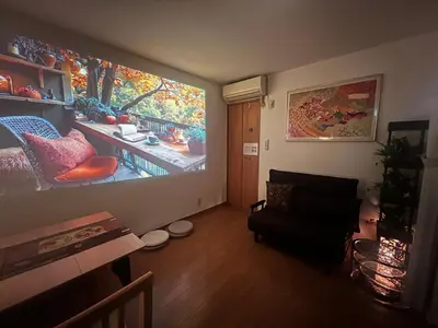 a living room with a large painting on the wall at Ayaka House Hirai in Tokyo