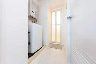 a white refrigerator in a kitchen with a window at \u30a8\u30c9\u30e2\u30c0\u30f3\u30b9\u30c6\u30a4 Edo Modern Stay 01 in Tokyo