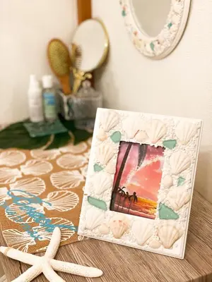a picture frame sitting on a table next to a mirror at Family Stay & Relaxation -Tokyo East- in Tokyo