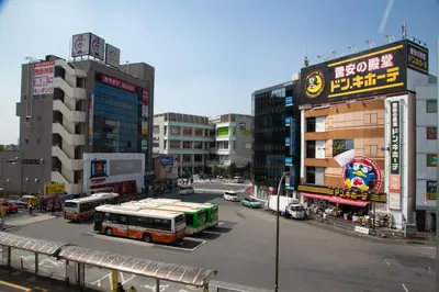 a city street with buses and buildings at Family Stay & Relaxation -Tokyo East- in Tokyo