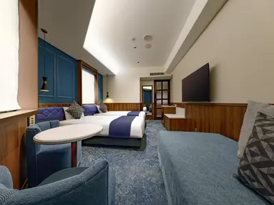 a hotel room with a bed and a flat screen tv at Villa Fontaine Tokyo Hibiya in Tokyo
