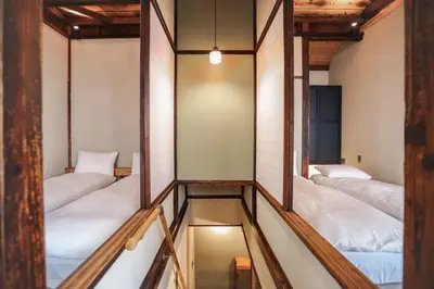 a corridor with four beds in a room at \u6771\u4eac\u4e0b\u753a\u751f\u6d3b in Tokyo