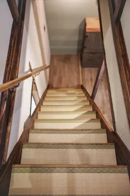 a set of stairs in a building with wooden ceilings at \u6771\u4eac\u4e0b\u753a\u751f\u6d3b in Tokyo