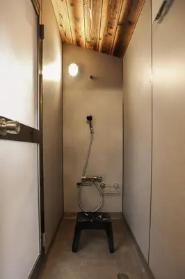 a bathroom with a shower in the corner of a room at \u6771\u4eac\u4e0b\u753a\u751f\u6d3b in Tokyo