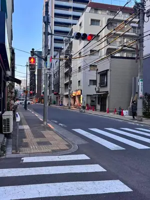 an empty city street with a traffic light and a crosswalk at Ikeda Ueno 201 Quad Room in Tokyo