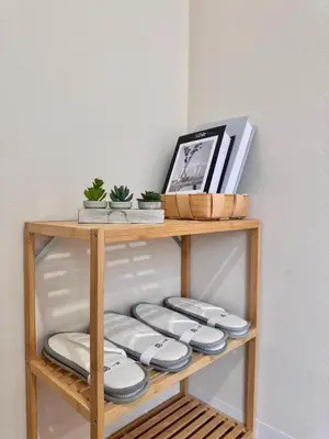 a wooden shelf with plates on top of it at Ikeda Ueno 201 Quad Room in Tokyo