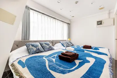a bedroom with two beds with a blue and white blanket at dir\u6075\u6bd4\u5bff\u897f2\u4e01\u76ee5a in Tokyo