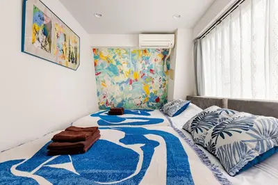 a bedroom with a bed with a blue and white rug at dir\u6075\u6bd4\u5bff\u897f2\u4e01\u76ee5a in Tokyo