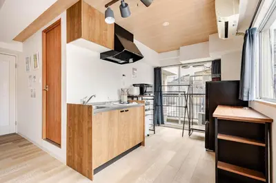 a kitchen with white walls and wooden cabinets at dir\u6075\u6bd4\u5bff\u897f2\u4e01\u76ee5a in Tokyo