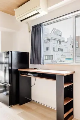 a kitchen with a table and a refrigerator at dir\u6075\u6bd4\u5bff\u897f2\u4e01\u76ee5a in Tokyo