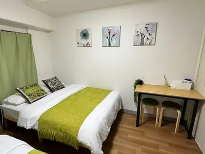 a bedroom with a bed and a desk with a table at 5min to\u65b0\u5bbfShinjuku in Tokyo