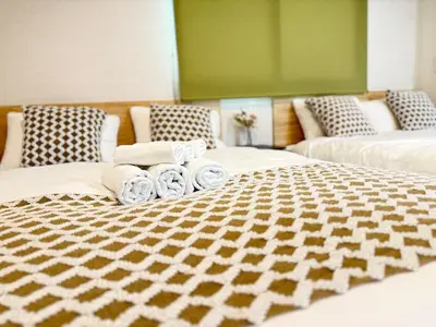 a room with two beds with towels on them at OmOTeNaShI YAHIRO in Tokyo