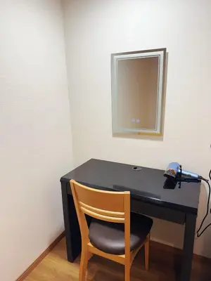 a black desk with a chair and a mirror at OmOTeNaShI YAHIRO in Tokyo