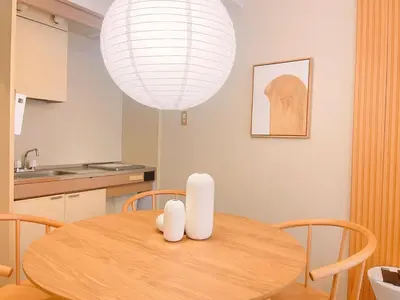 a dining room with a table and a light fixture at The perfect place to experience the best of Ikebukuro in Tokyo