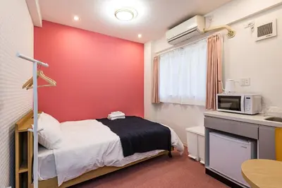 a hospital room with a bed and a microwave at ViLLA SAKURA \u6771\u4eac\u76ee\u9ed2 in Tokyo