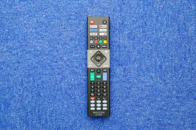a remote control sitting on top of a blue pillow at ViLLA SAKURA \u6771\u4eac\u76ee\u9ed2 in Tokyo