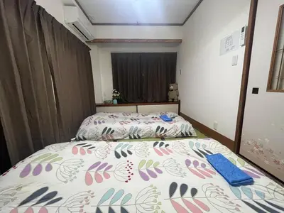 a bedroom with a bed with a colorful bedspread at Sweet House \u677f\u6a4b in Tokyo