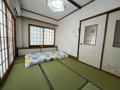 a bedroom with a bed in a room with windows at Sweet House \u677f\u6a4b in Tokyo