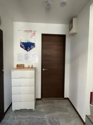 a hallway with a door and a dresser at Sweet House \u677f\u6a4b in Tokyo