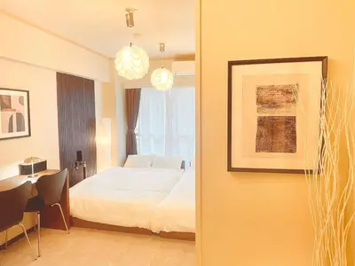 a bedroom with a bed and a desk with a table sidx sidx sidx at A cozy hidden gem in Ikebukuro in Tokyo