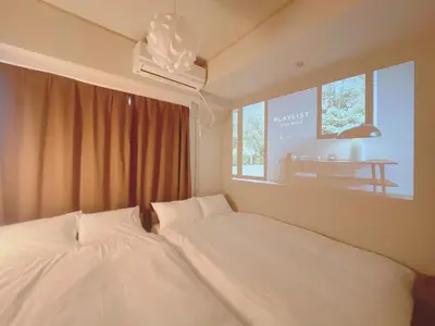 a bedroom with two white beds and a window at A cozy hidden gem in Ikebukuro in Tokyo