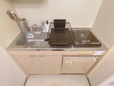 a kitchen counter with a stove and a sink at A cozy hidden gem in Ikebukuro in Tokyo