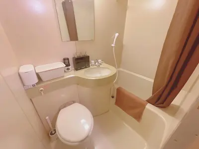 a small bathroom with a toilet and a sink at A cozy hidden gem in Ikebukuro in Tokyo