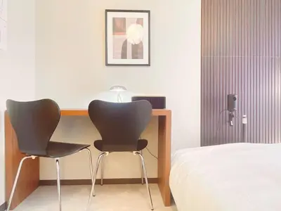 two chairs sitting on a desk next to a bed at A cozy hidden gem in Ikebukuro in Tokyo