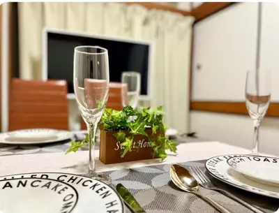 a table with two wine glasses and a plant on it at 6 minutes to Shinjuku, 10 minutes to Shibuya, accommodating 6 people in Tokyo