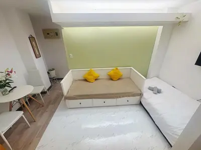a small room with a couch and two yellow pillows at Asakusa Sakura-1F in Tokyo