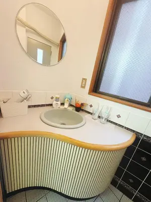 a bathroom with a sink and a mirror at Asakusa Sakura-1F in Tokyo