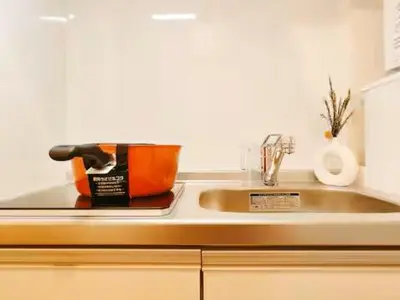 a kitchen sink with an orange pot on it at Minami Ikebukuro APT Dear Cosmo Ikebukuro subway 6mins in Tokyo