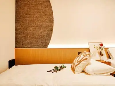 a bedroom with a white bed with flowers on it at Minami Ikebukuro APT Dear Cosmo Ikebukuro subway 6mins in Tokyo