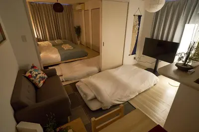 a small living room with a bed and a couch at Lavi'n Asakusa ラヴィン浅草 in Tokyo