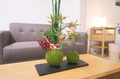 two green vases with plants on a table at Lavi'n Asakusa ラヴィン浅草 in Tokyo