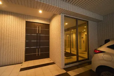 a garage with a glass door with a car parked in it at Lavi'n Asakusa ラヴィン浅草 in Tokyo