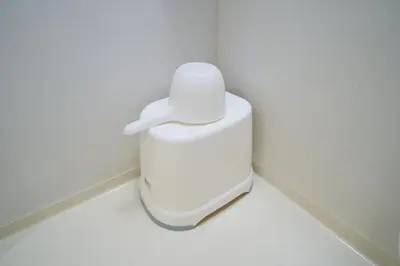 a white toilet in a corner of a bathroom at Lavi'n Asakusa ラヴィン浅草 in Tokyo