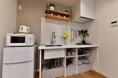 a small kitchen with a sink and a microwave at -Grandir Shibuya- 7-minute walk to Shibuya Station in Tokyo
