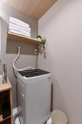 a small bathroom with a washing machine in a room at -Grandir Shibuya- 7-minute walk to Shibuya Station in Tokyo